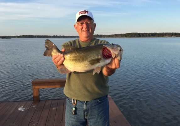 Butch Sauer holding a trophy bass on Lake Fork during a guided fishing trip.