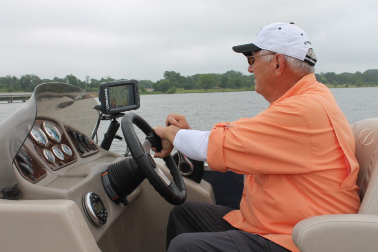 Butch Sauer guiding a fishing trip on Lake Fork from the helm of his boat